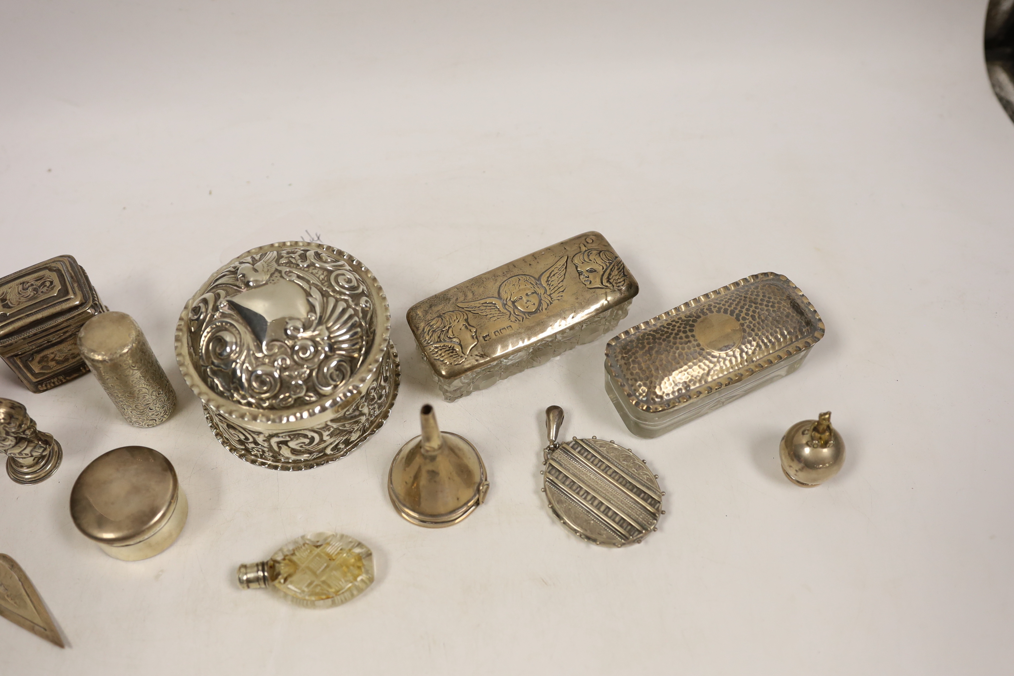 Small silver including two silver mounted glass toilet boxes, a Victorian engraved scent bottle by Sampson Mordan, a perfume funnel, Edwardian Shakespeare bust seal, repousse box and cover, locket, bookmark, etc.